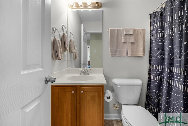 bathroom featuring vanity and toilet