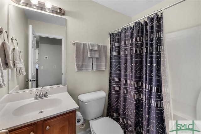 bathroom featuring walk in shower, vanity, and toilet