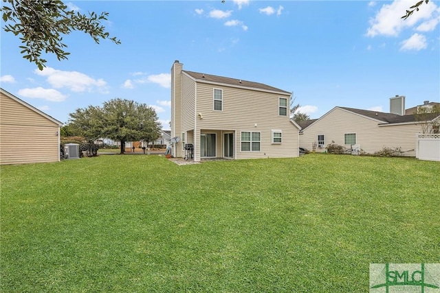 back of property featuring a yard and central AC