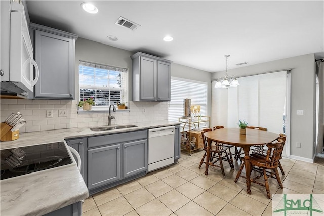 kitchen with white appliances, gray cabinets, and sink