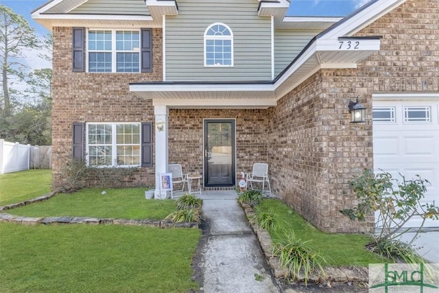 entrance to property with a yard and a garage