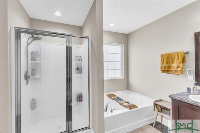 bathroom with independent shower and bath and vanity