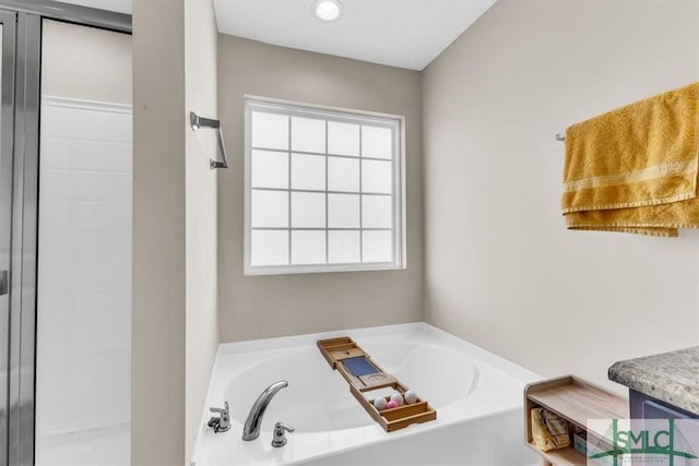 bathroom featuring vanity and plus walk in shower