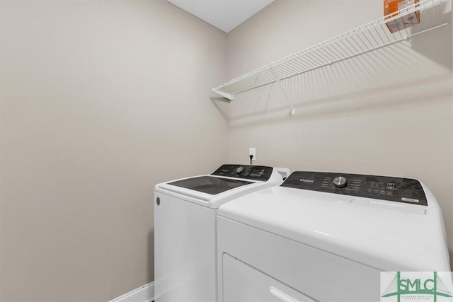 laundry area with washing machine and clothes dryer