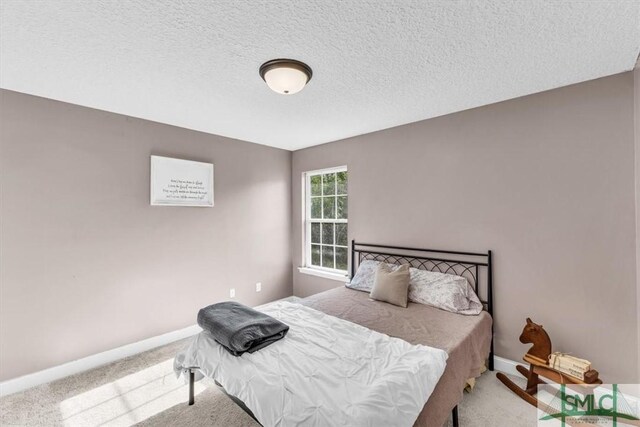 carpeted bedroom with a textured ceiling