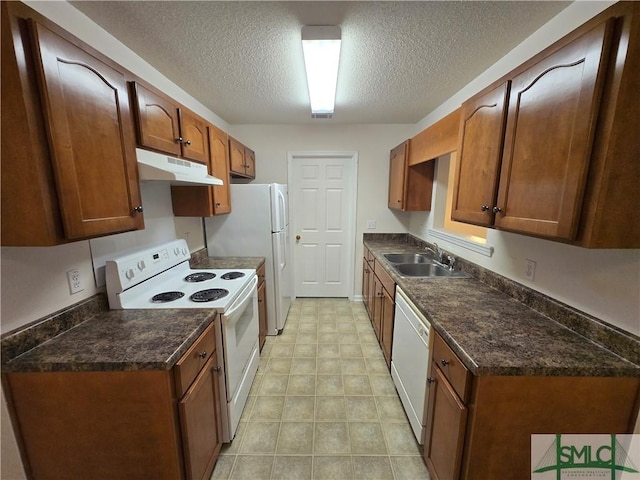 kitchen with sink, a textured ceiling, and white appliances