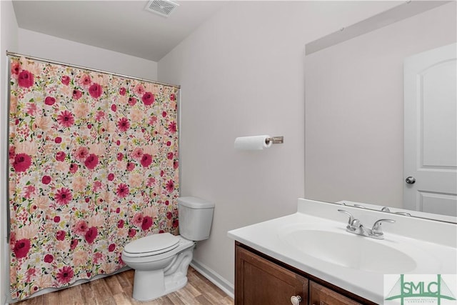 bathroom with hardwood / wood-style flooring, vanity, toilet, and a shower with shower curtain