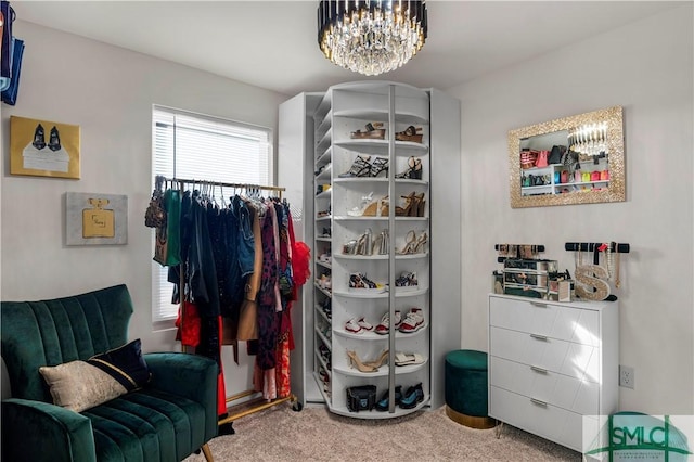 spacious closet with carpet and a chandelier