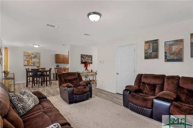 living room with light hardwood / wood-style flooring