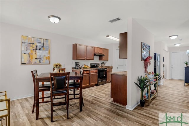 dining space with light wood-type flooring