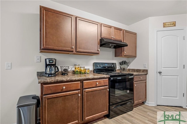 kitchen with black range with electric stovetop and light hardwood / wood-style floors