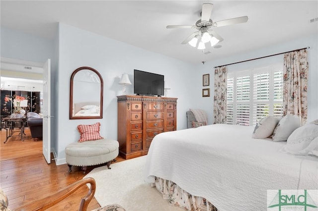 bedroom with wood-type flooring and ceiling fan