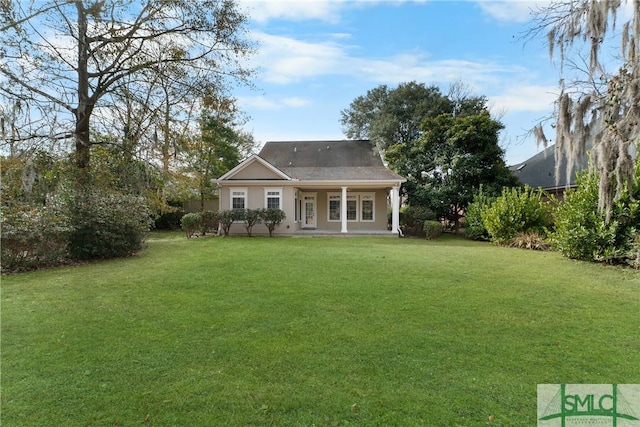 rear view of house with a yard