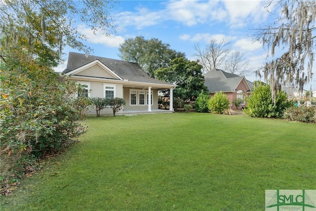 rear view of house with a yard