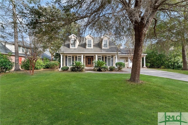 cape cod home with a garage, a front yard, and covered porch