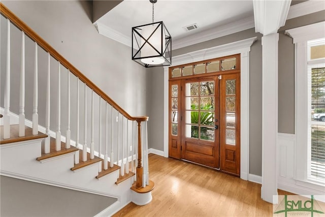 entrance foyer featuring crown molding and light hardwood / wood-style flooring