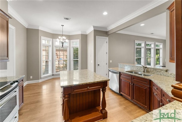 kitchen with appliances with stainless steel finishes, a breakfast bar, sink, hanging light fixtures, and light stone counters