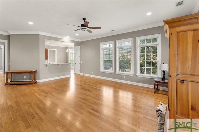 unfurnished living room with crown molding, ceiling fan with notable chandelier, and light wood-type flooring