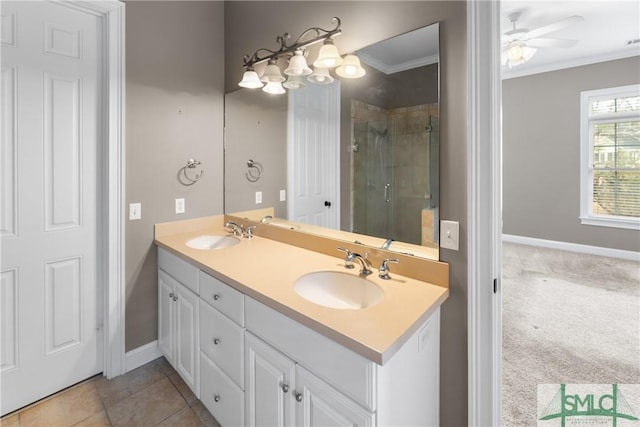 bathroom featuring vanity, tile patterned flooring, ornamental molding, and walk in shower