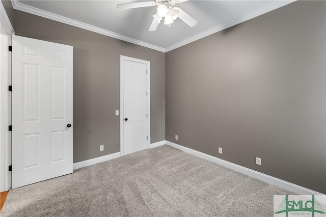 unfurnished bedroom featuring crown molding, ceiling fan, and carpet flooring