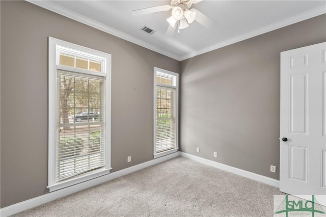 spare room with ornamental molding, light colored carpet, and ceiling fan