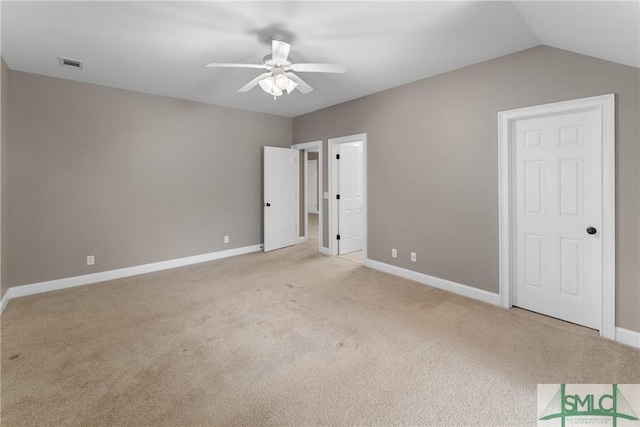 unfurnished bedroom with ceiling fan, light colored carpet, and vaulted ceiling