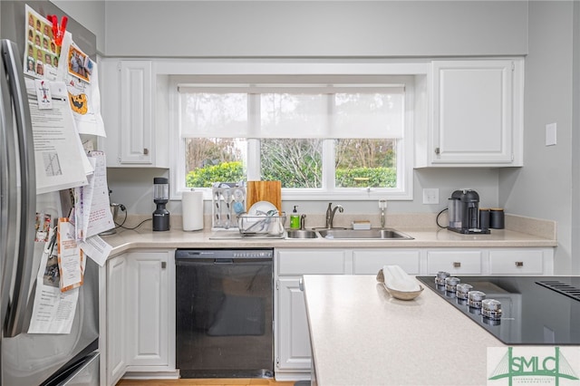 kitchen with white cabinetry, sink, and black appliances