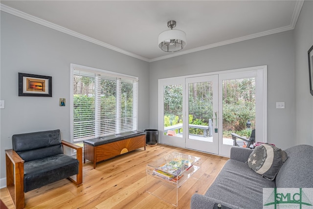 living room featuring french doors, plenty of natural light, crown molding, and hardwood / wood-style flooring