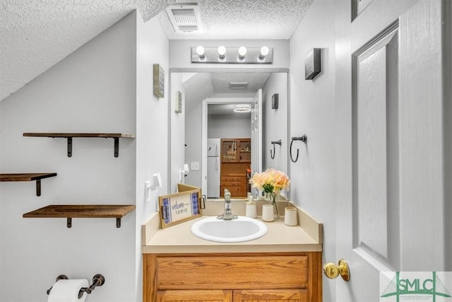 bathroom with vanity and a textured ceiling