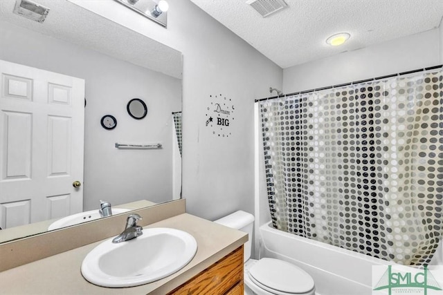 full bathroom featuring vanity, toilet, a textured ceiling, and shower / bath combo