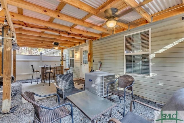 view of patio / terrace featuring cooling unit, ceiling fan, and exterior bar