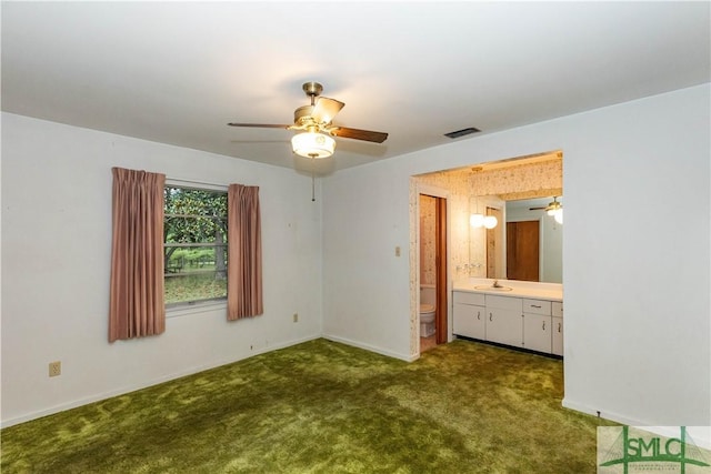 unfurnished bedroom featuring connected bathroom, sink, and carpet