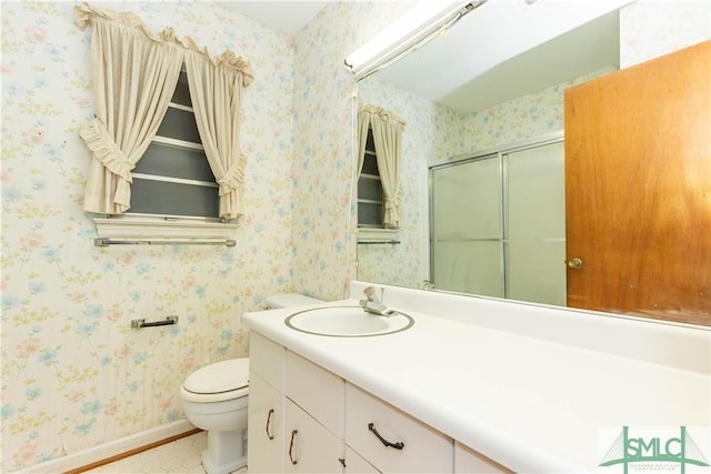 bathroom with vanity, toilet, and an enclosed shower