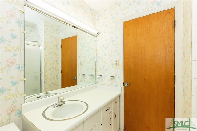 bathroom featuring an enclosed shower and vanity