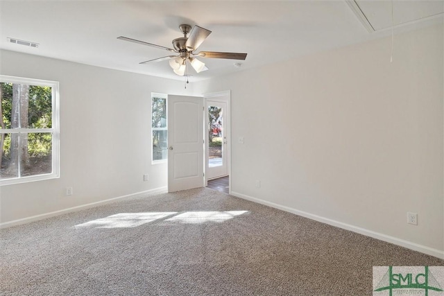 carpeted spare room with ceiling fan