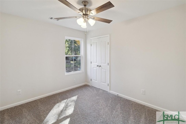 spare room with ceiling fan and carpet flooring