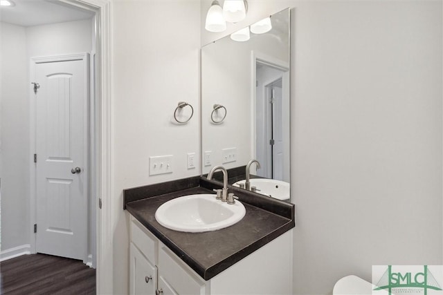 bathroom with vanity and hardwood / wood-style floors