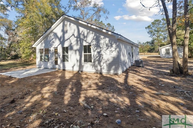 rear view of house featuring central AC and a patio area