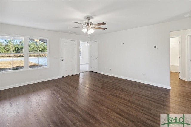 spare room with dark hardwood / wood-style flooring and ceiling fan