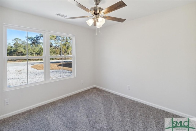 unfurnished room with ceiling fan and carpet