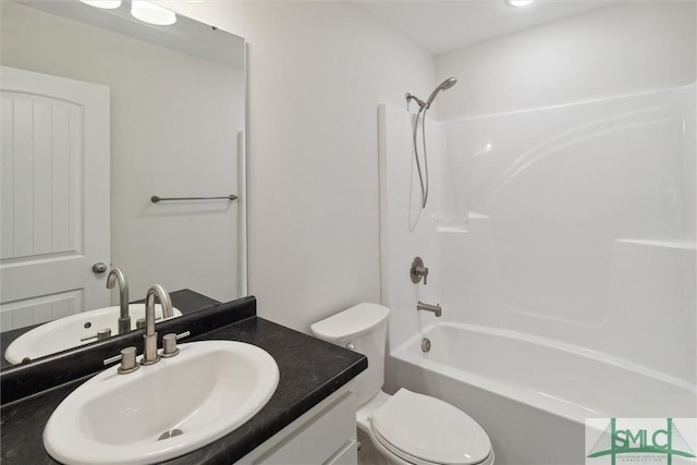 full bathroom featuring vanity, washtub / shower combination, and toilet