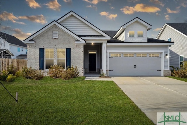 craftsman-style house with a garage and a lawn