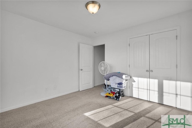 interior space featuring a closet and carpet