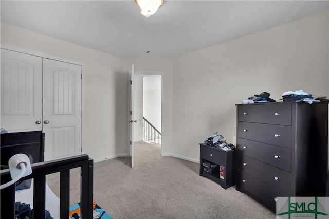 bedroom featuring a closet and light carpet