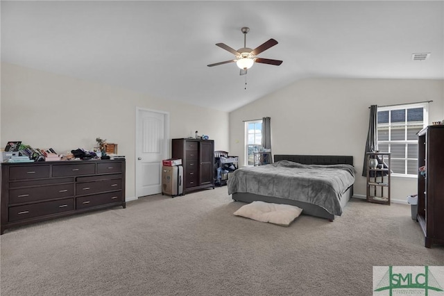 bedroom featuring light carpet, vaulted ceiling, and ceiling fan