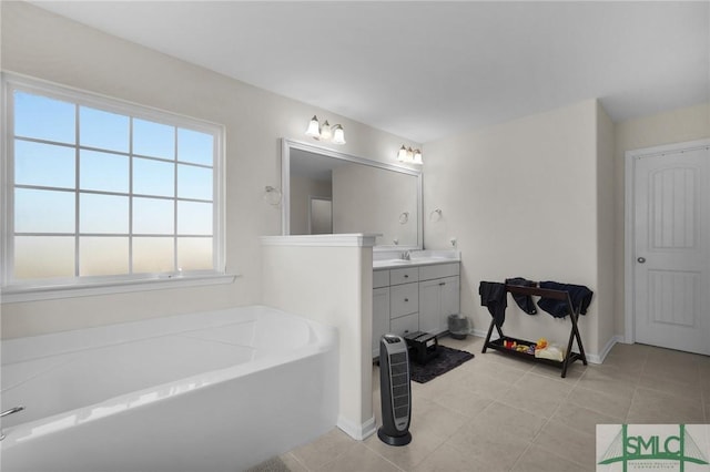 bathroom with vanity, a washtub, and tile patterned floors