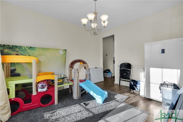 rec room with dark hardwood / wood-style flooring and a chandelier