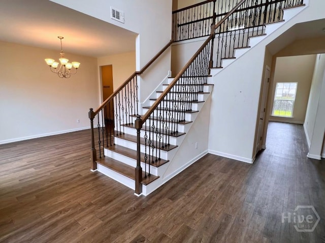 125 Grimsby Rd, Savannah, GA 31407 - stairs with wood finished floors, a chandelier, baseboards, and a high ceiling