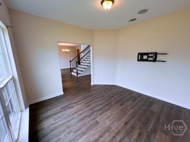 125 Grimsby Rd, Savannah, GA 31407 - spare room featuring a chandelier, dark wood-style floors, baseboards, and stairs