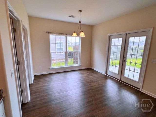 125 Grimsby Rd, Savannah, GA 31407 - unfurnished dining area featuring dark wood-type flooring, french doors, baseboards, and a chandelier